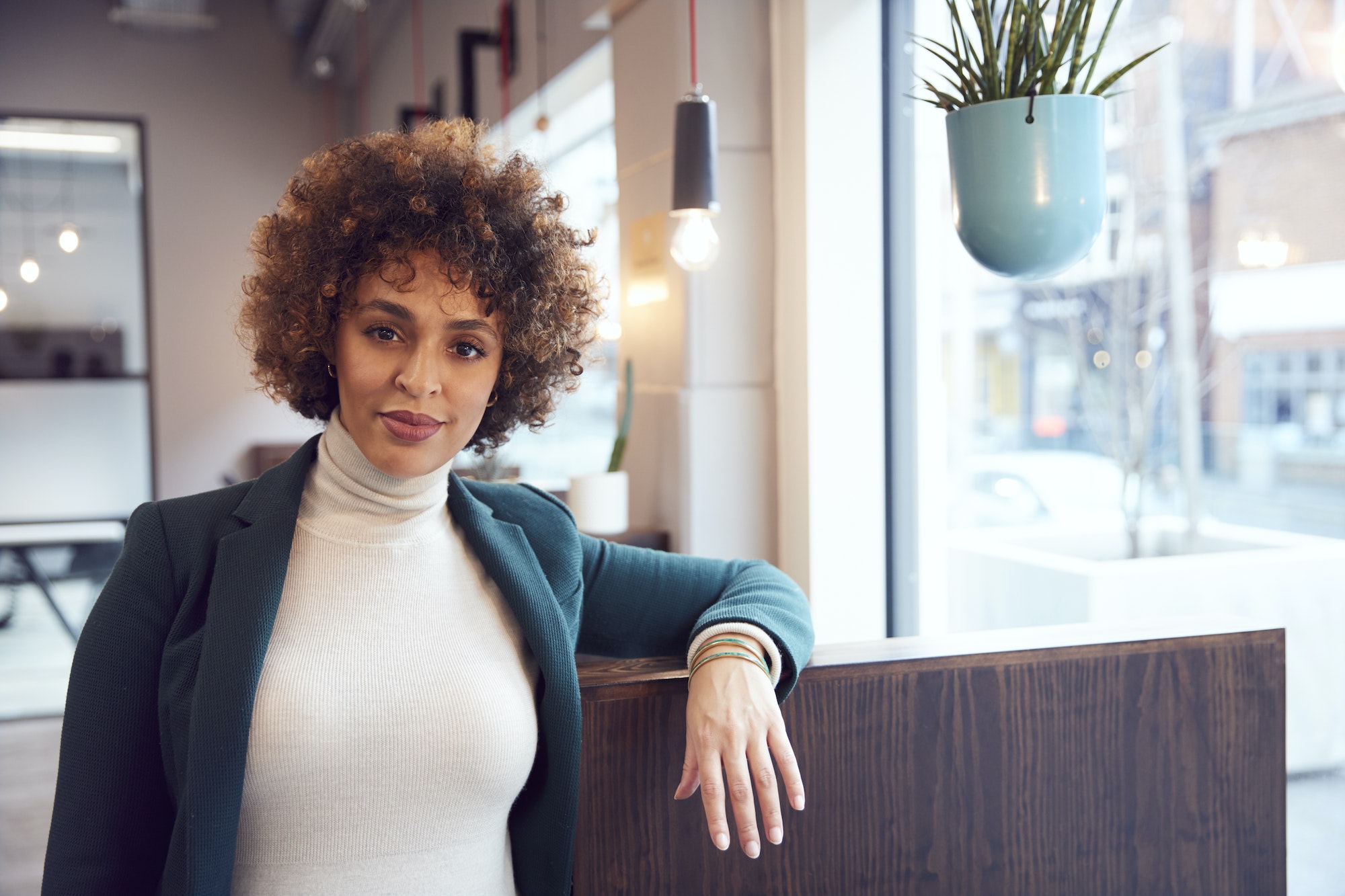 Head And Shoulders Portrait Of Businesswoman Working In Modern Office